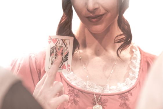 promo photo of woman holding playing card