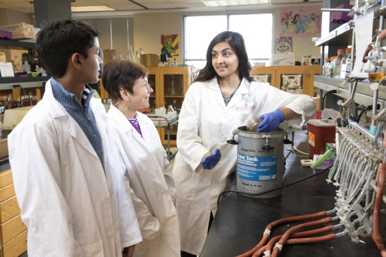 photo of three people in laboratory, with white lab coats