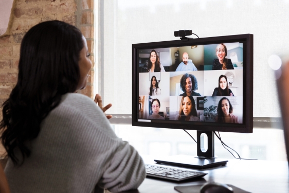 photo of woman looking at computer screen with faces