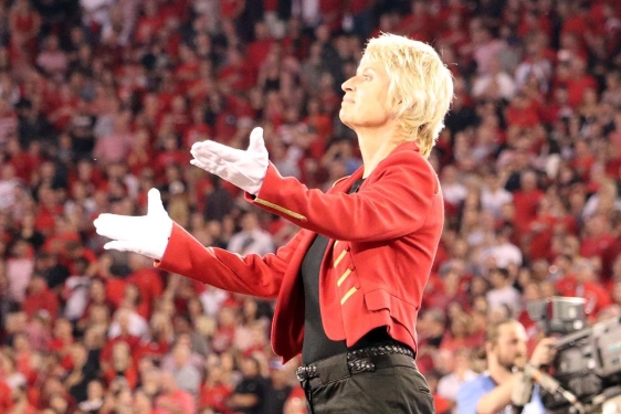 photo of conductor on platform at sporting event
