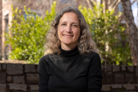 photo of woman, outdoors, with wall