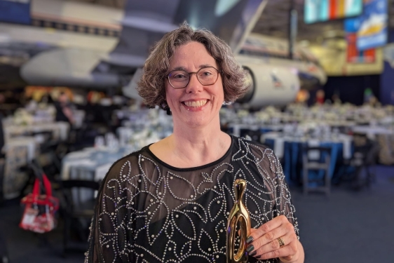 photo of woman with award trophy