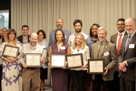 group photo of people holding plaques