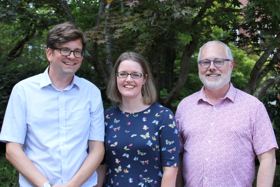 photo of three people, outdoors