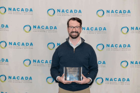 photo of man holding plaque