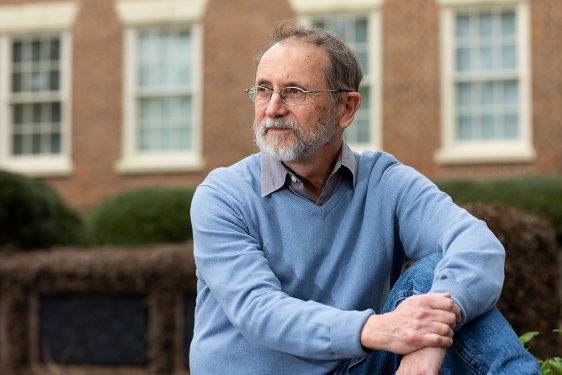photo of man, with building in background