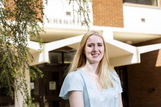 photo of woman in front of building, day