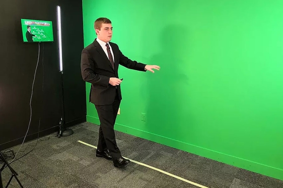photo of man in suit with green wall
